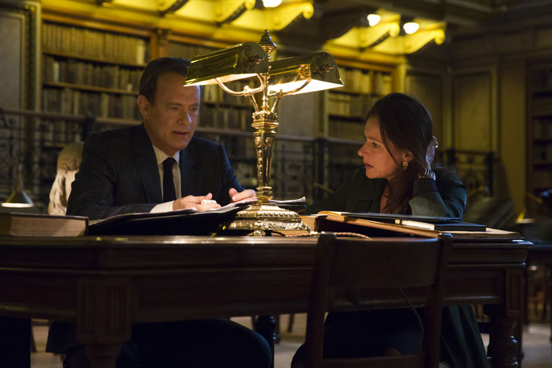 Sinskey (Sidse Babett Knudsen) and Robert Langdon (Tom Hanks) analyze Dante's text in Columbia Pictures' INFERNO.